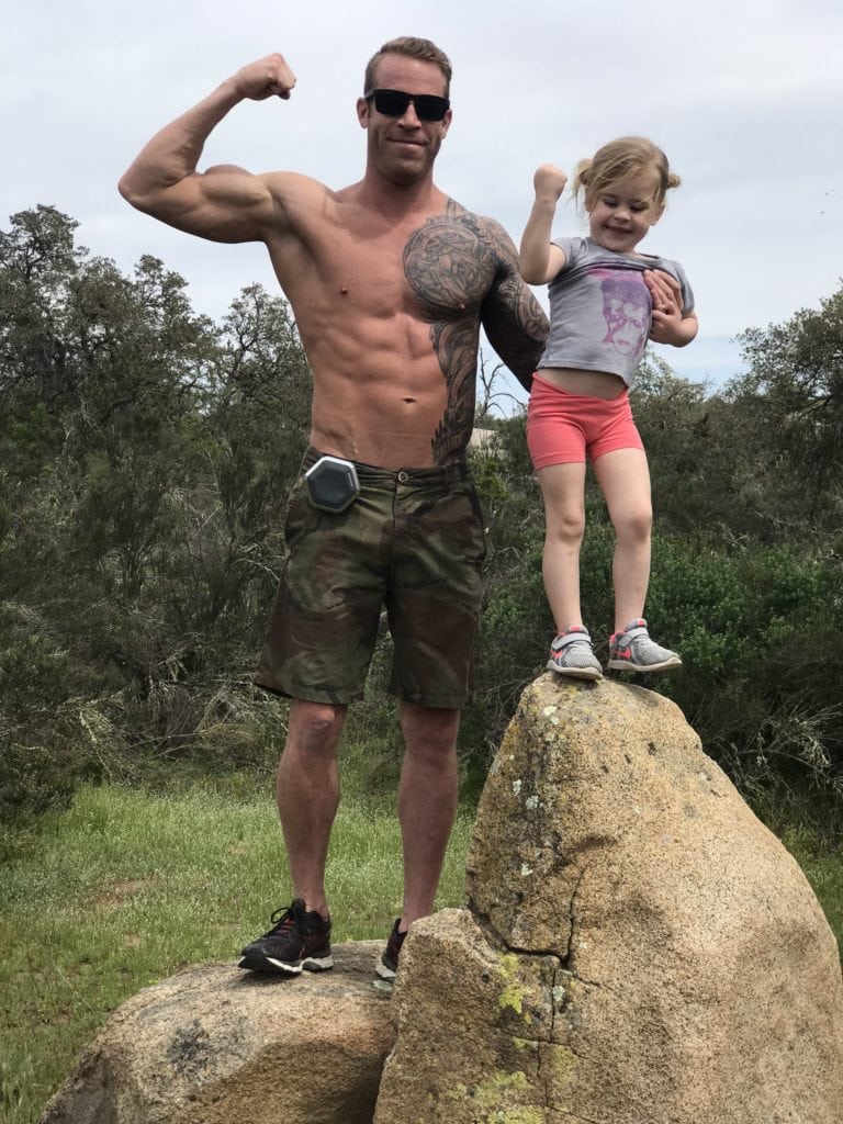 dad and daughter flexing