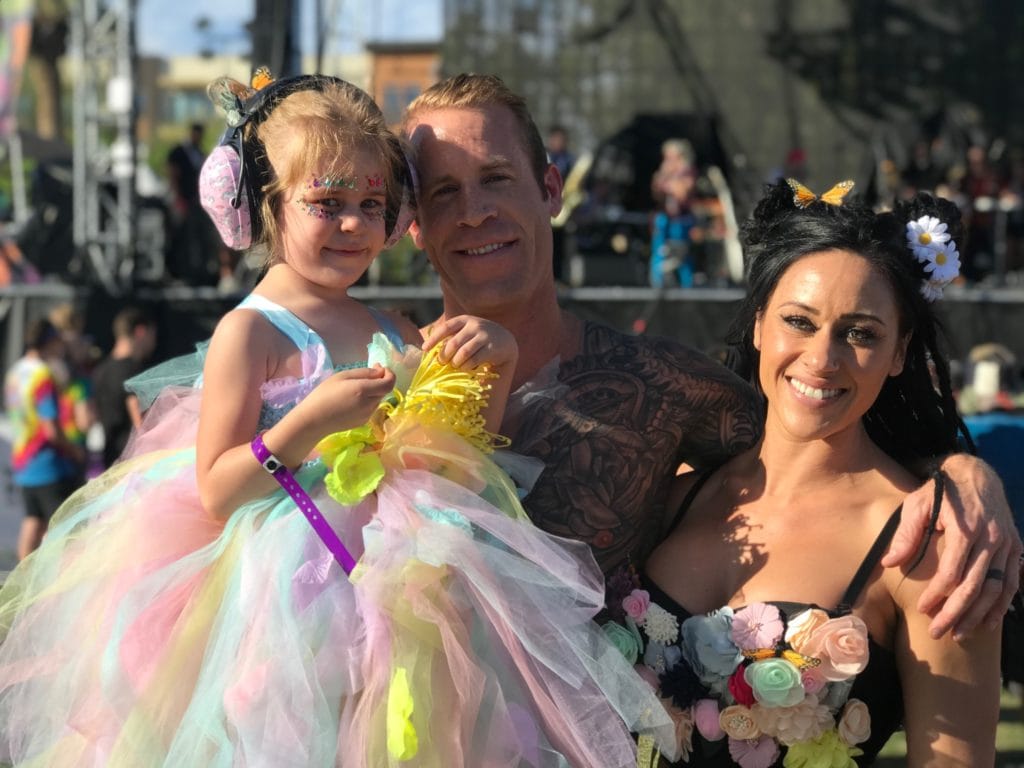 mom and dad with daughter at her first festival